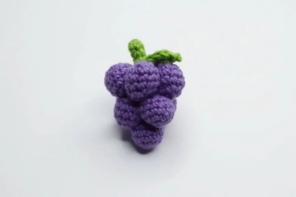 Grape amigurumi keychain made of small purple crochet grapes