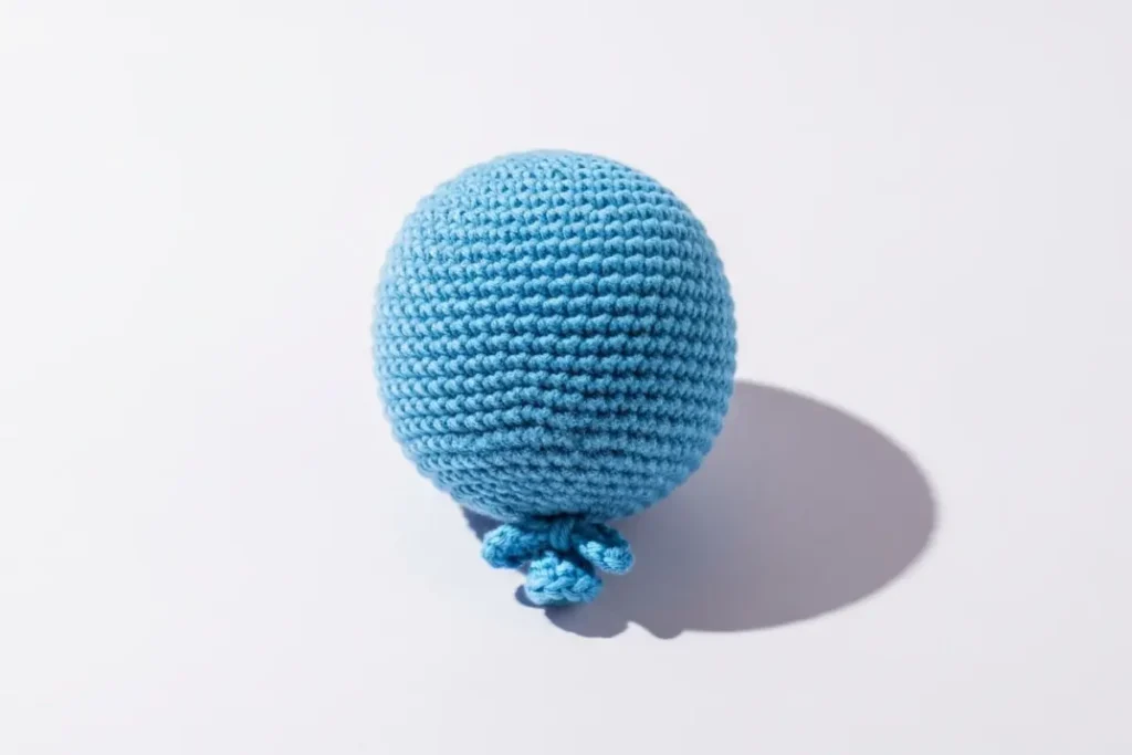 small handmade mini amigurumi crochet balloon in bright yarn