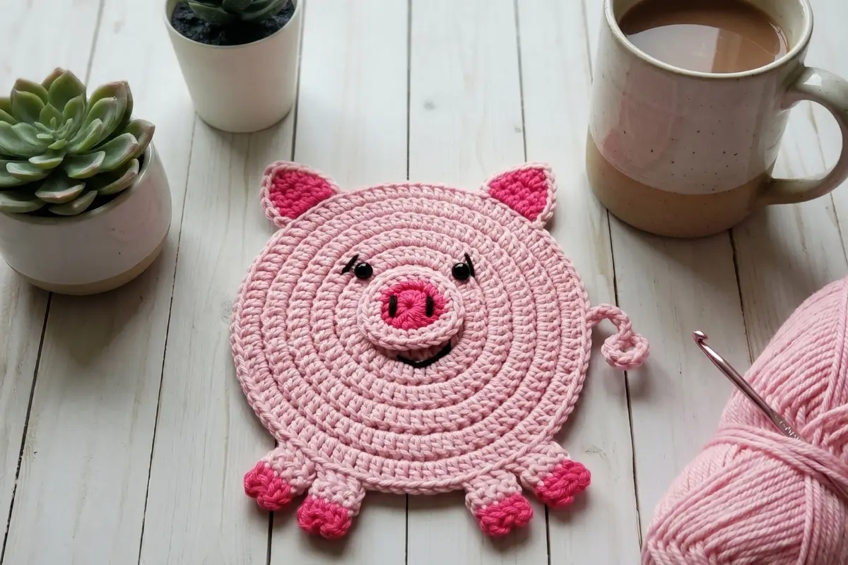 Cute crochet pig coaster pattern made with pink cotton yarn in US crochet terms