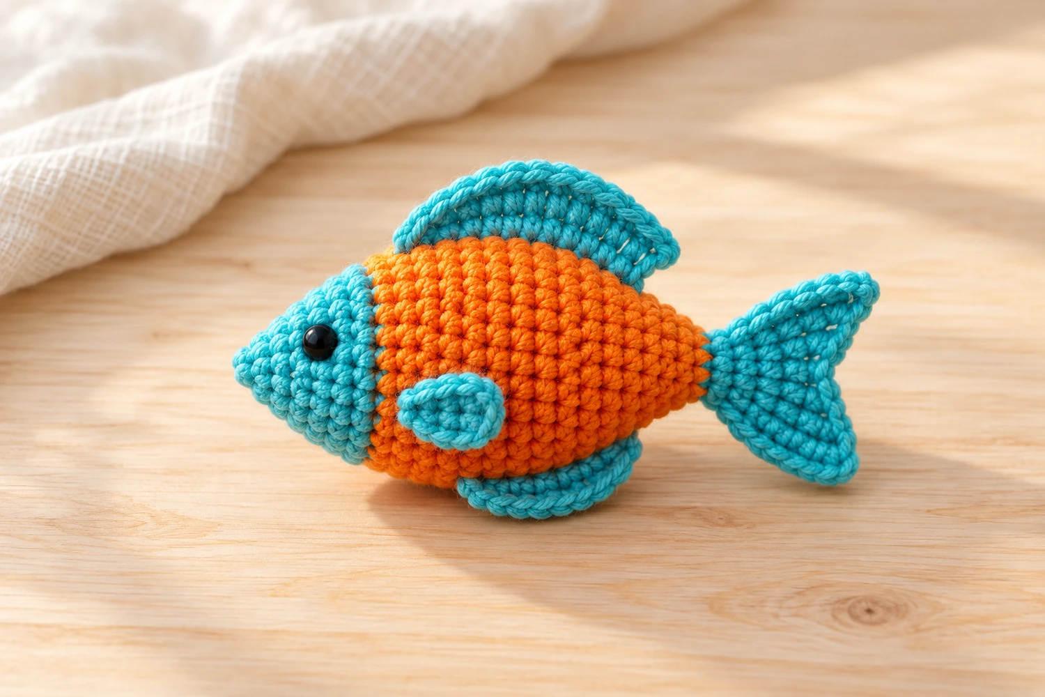 Fish Amigurumi Crochet Pattern with a turquoise head and fins and an orange body